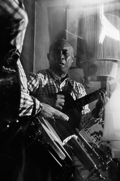 musician playing guitar in in the night club