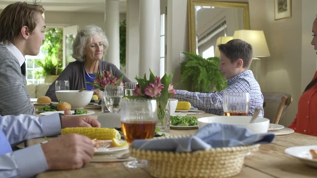 Boy receiving cash in birthday card from grandmother.