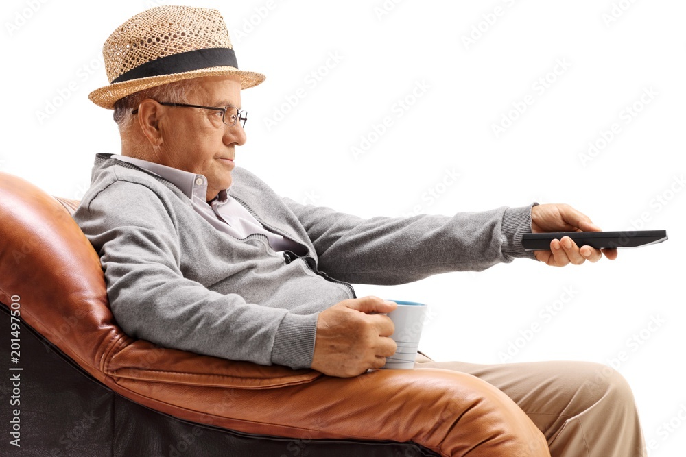 Poster Bored elderly man sitting in an armchair and watching television