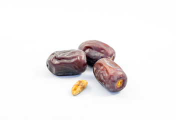 Dried date and seed on white background