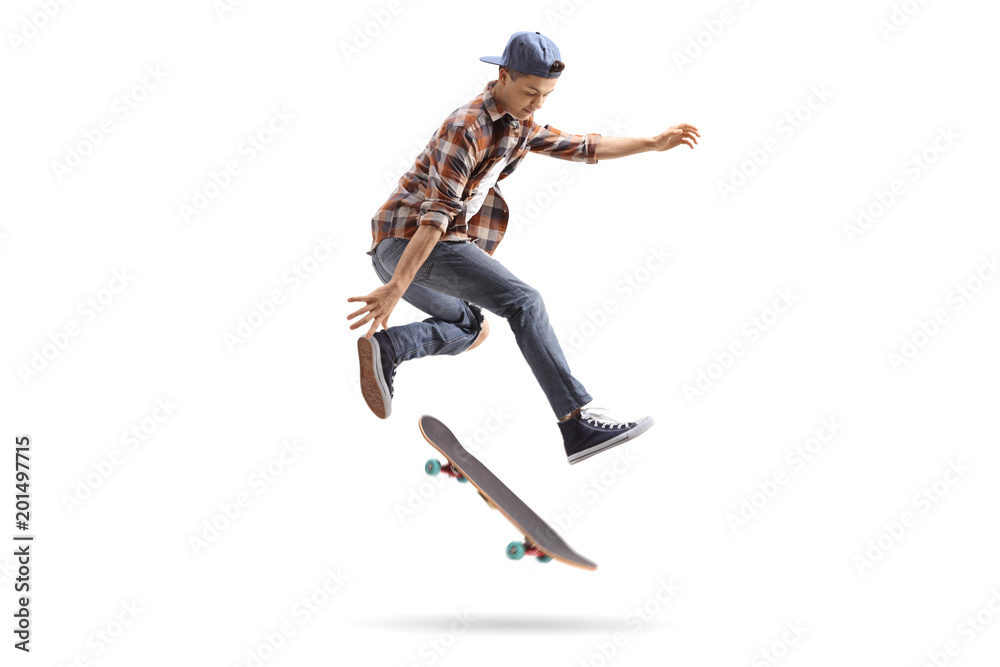 Wall mural teenage skater performing a trick with a skateboard