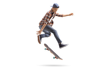 Teenage skater performing a trick with a skateboard - obrazy, fototapety, plakaty