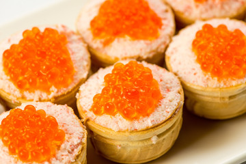 Tartlets with cheese and red caviar. Selective focus. Copy space