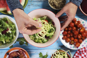 young man preparing a buddha bowl