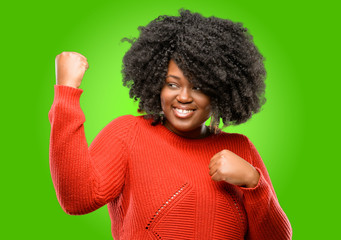 Fototapeta na wymiar Beautiful african woman happy and excited celebrating victory expressing big success, power, energy and positive emotions. Celebrates new job joyful