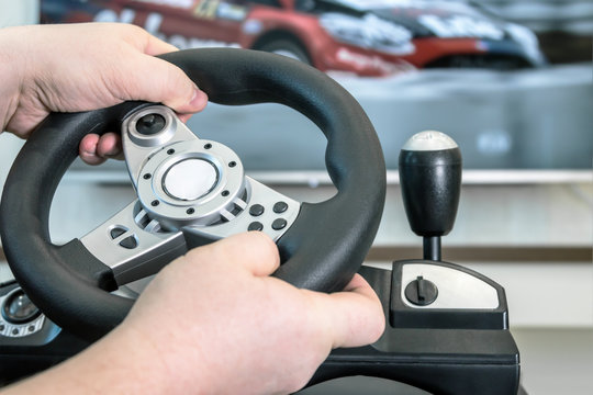 Playing In The Race Behind The Wheel Of A Game Console  