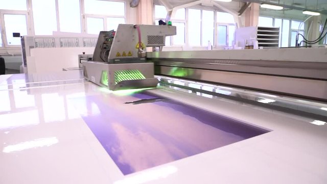UV printer. The equipment works in the shop. Drawing image