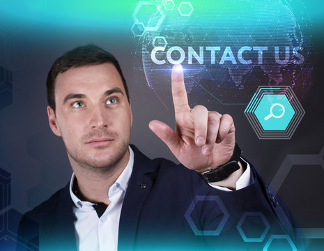 Business, Technology, Internet and network concept. Young businessman working on a virtual screen of the future and sees the inscription: Contact us