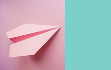 Paper plane on pink background.