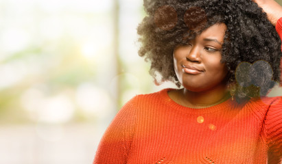 Beautiful african woman doubt expression, confuse and wonder concept, uncertain future, outdoor