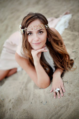 Portrait of a beautiful amazing girl with kind eyes, gentle  smile, long curly hair.  Young happy woman walking on the autumn gold field