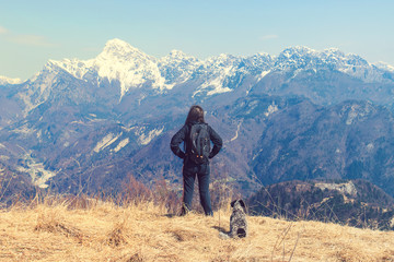 Fototapeta premium woman with dog enjoying the mountains. Sportive Girl Exploring The Nature 