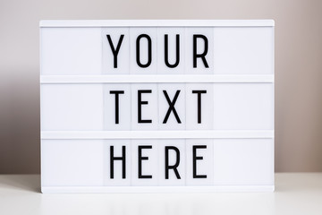 lightbox with words "your text here" on the table