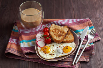 Healthy simple breakfast with bread toast, fried eggs and vegetables