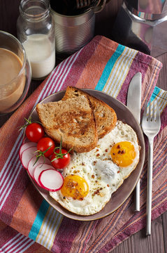 Healthy simple breakfast with bread toast, fried eggs and vegetables
