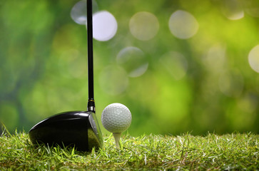 Golf ball on green grass ready to be struck on golf course background