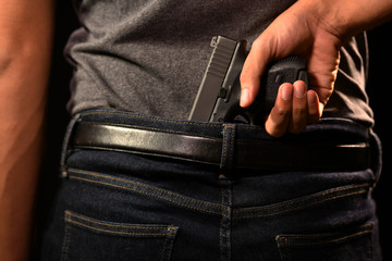 The man concealing gun behind his back