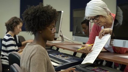 Young woman in music lesson with college tutor.