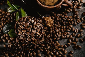 Cup of brewed coffee among aromatic beans