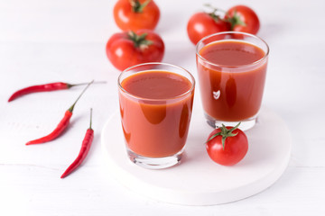 Glasses of Tasty Tomato Juice with Raw Tomatoes on White Wooden Background Healthy Diet Detox Drink