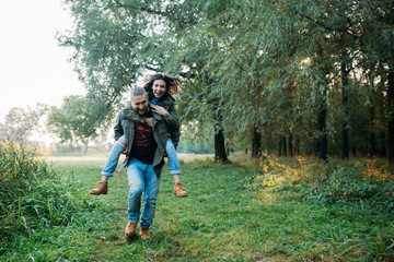 Fototapeta na wymiar Walk a guy and a girl. Love story in the forest. Youth in nature.