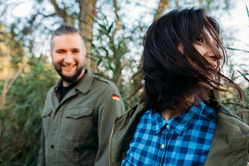 Walk a guy and a girl. Love story by the lake in the tall grass. Youth in nature.