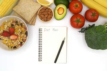concept diet plan, healthy food with muesli, bread, corn, almond, lemon, avocado, tomato, banana, broccoli, strawberry, fresh organic fruit and vegetable with notebook and pen, breakfast 