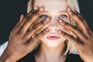 Fototapeta premium cropped image of african american boyfriend touching blonde girlfriend face isolated on black