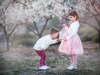 little brother and sister playing in the park