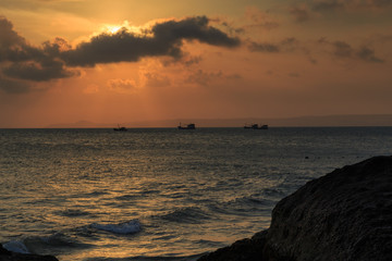 fishing boat to the sea at sunset