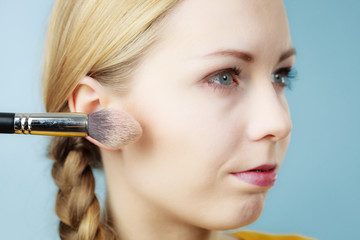 Obraz premium Makeup artist applying with brush rouge on female check