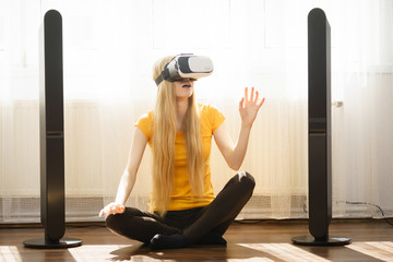 Girl wearing virtual reality goggles at home