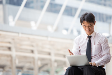 Fototapeta premium Asian businessman working on train station