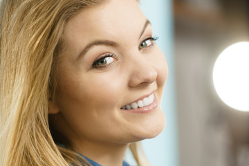 Portrait of happy blonde woman smiling with joy