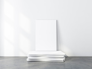 White Canvas Mockup standing on pack of frames in empty room. 3d rendering