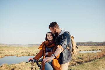 couple in love on a bike on nature in autumn