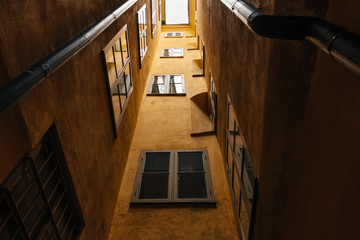 Wall with windows of an orange building in old part of a European town.