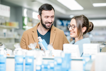 Fototapeta premium Couple choosing cosmetics in the pharmacy