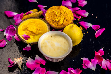 Chana,haldi,limbo & milk  ka ubtan or ayurvedic face pack of Turmeric, Lemon,gram flour & milk on wooden surface for good skin and no black heads or any skin related problems.