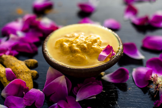 Chana,haldi,limbo & milk  ka ubtan or ayurvedic face pack of Turmeric, Lemon,gram flour & milk on wooden surface for good skin and no black heads or any skin related problems.