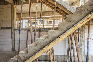 New house construction with concrete staircase at building site