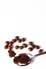 Grain of coffee, beans and a coffee spoon on a white background. Close-up