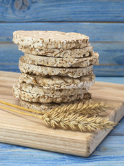 corn crackers on a blue wooden background.  © homohomozaza