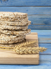 corn crackers on a blue wooden background.  © homohomozaza