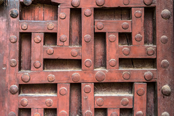 Old wooden door with decorative pattern in India