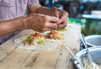 Women making spring roll in the market,Thailand  street food,asian Chinese style