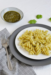 Cooked fusilli pasta on a plate with pesto, Italy food, healthy concept, vegetarian