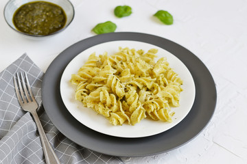 Cooked fusilli pasta on a plate with pesto, Italy food, healthy concept, vegetarian