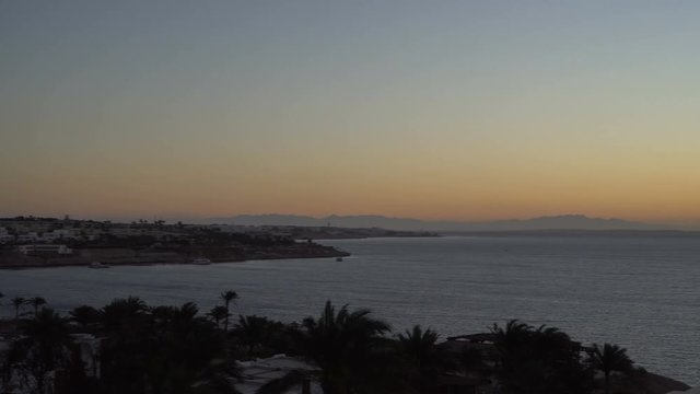 Rising Sun over the sea and desert mountains