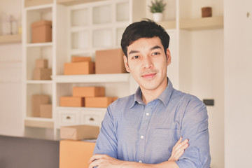 Obraz premium Sme business concept. Young Asian people are packing their packages.Delivery business Small and Medium Enterprise (SMEs). Young man is working in the house.Young Owner Start up for Business Online.